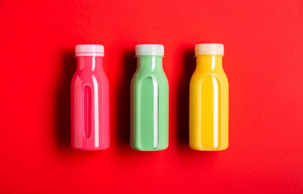 Home 3 three colorful smoothies red background 1024x657 1 - healthy Fresh juice %